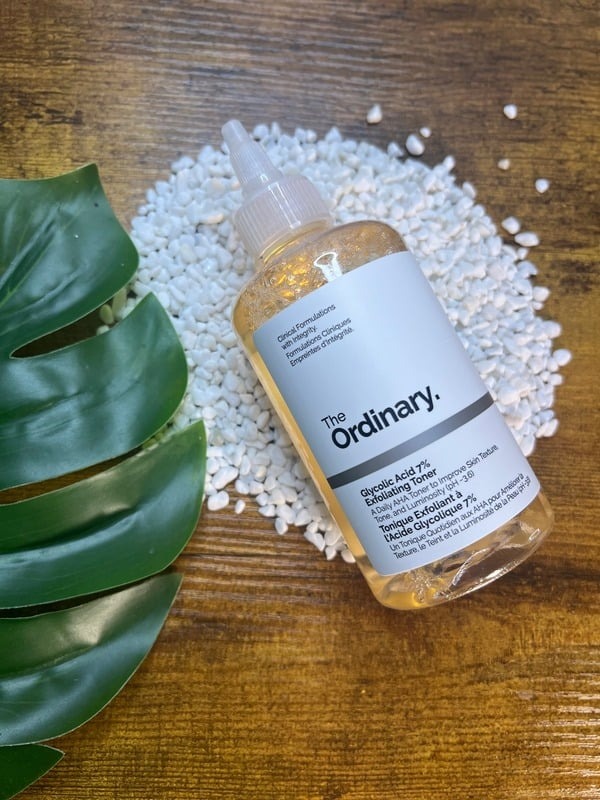 The Ordinary toner on wood with bath salts and a monstera leaf